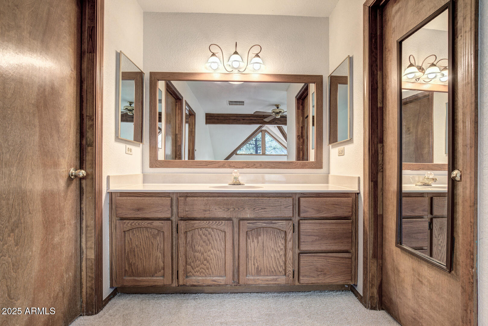 5115 Monte Vista Pine, AZ 85544 - Photo 25 of 35 a bathroom with a sink and a mirror