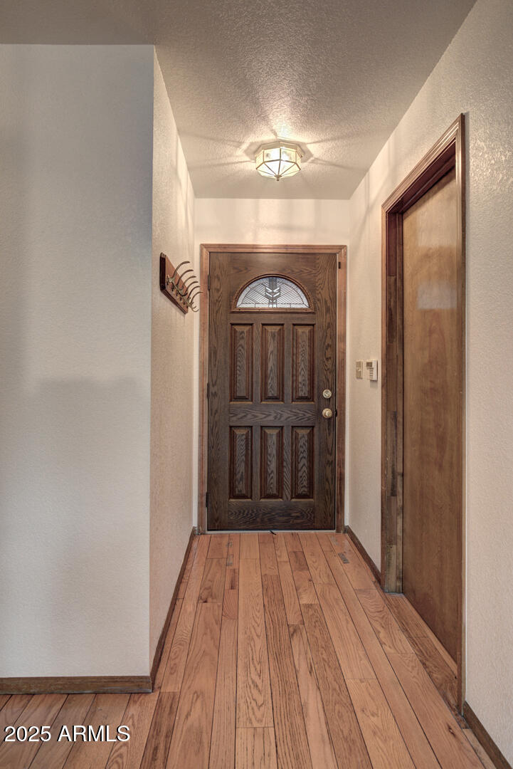 5115 Monte Vista Pine, AZ 85544 - Photo 4 of 35 a view of a hallway with wooden floor