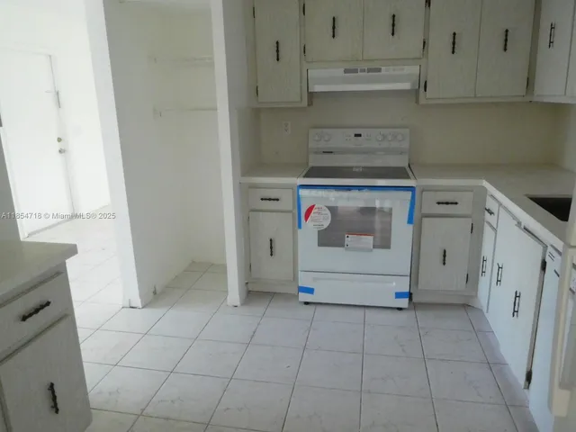 a utility room with cabinets washer and dryer