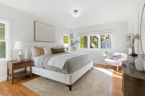a spacious bedroom with a bed and a table