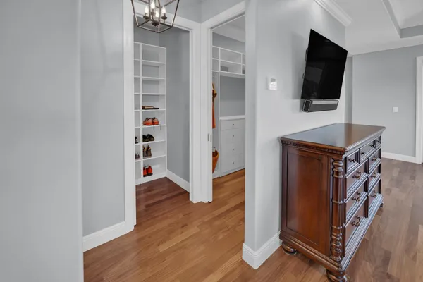 a spacious bedroom with two bed and a chandelier