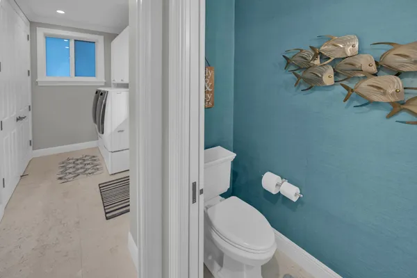 a bathroom with a sink a toilet a mirror and shower