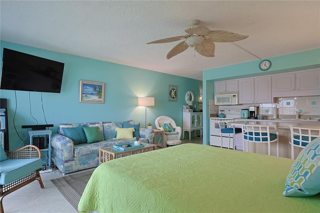 3700 South Atlantic Avenue, Unit 414 New Smyrna Beach, FL 32169 - Photo 16 of 30 a living room with furniture and a flat screen tv
