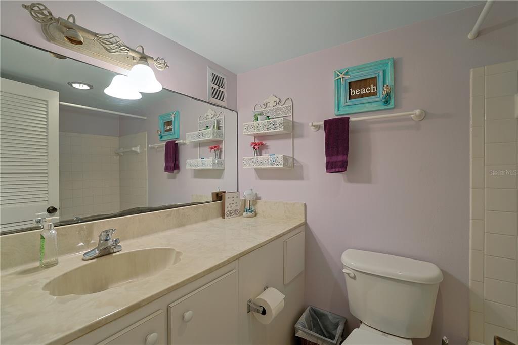 3700 South Atlantic Avenue, Unit 414 New Smyrna Beach, FL 32169 - Photo 20 of 30 a bathroom with a granite countertop sink mirror vanity and toilet