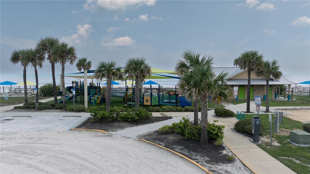 3700 South Atlantic Avenue, Unit 414 New Smyrna Beach, FL 32169 - Photo 22 of 30 a front view of a house with garden