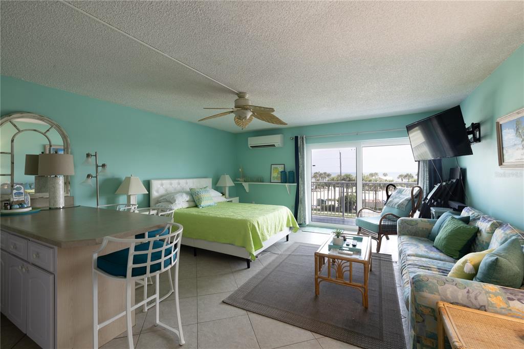 3700 South Atlantic Avenue, Unit 414 New Smyrna Beach, FL 32169 - Photo 25 of 30 a living room with furniture and a large window