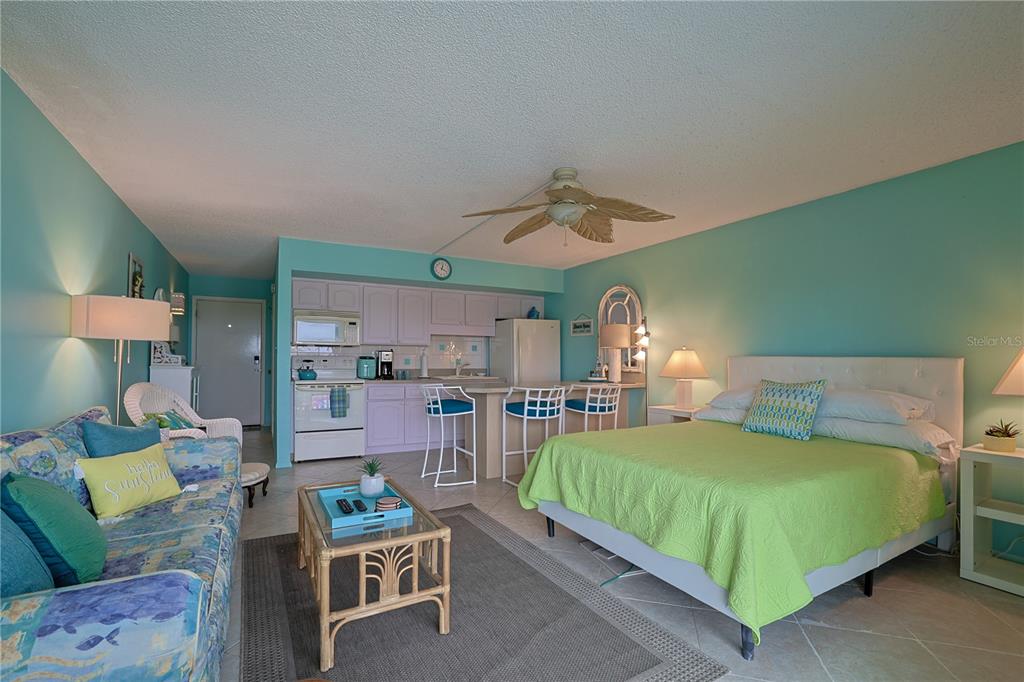 3700 South Atlantic Avenue, Unit 414 New Smyrna Beach, FL 32169 - Photo 10 of 30 a bedroom with a bed window and couch