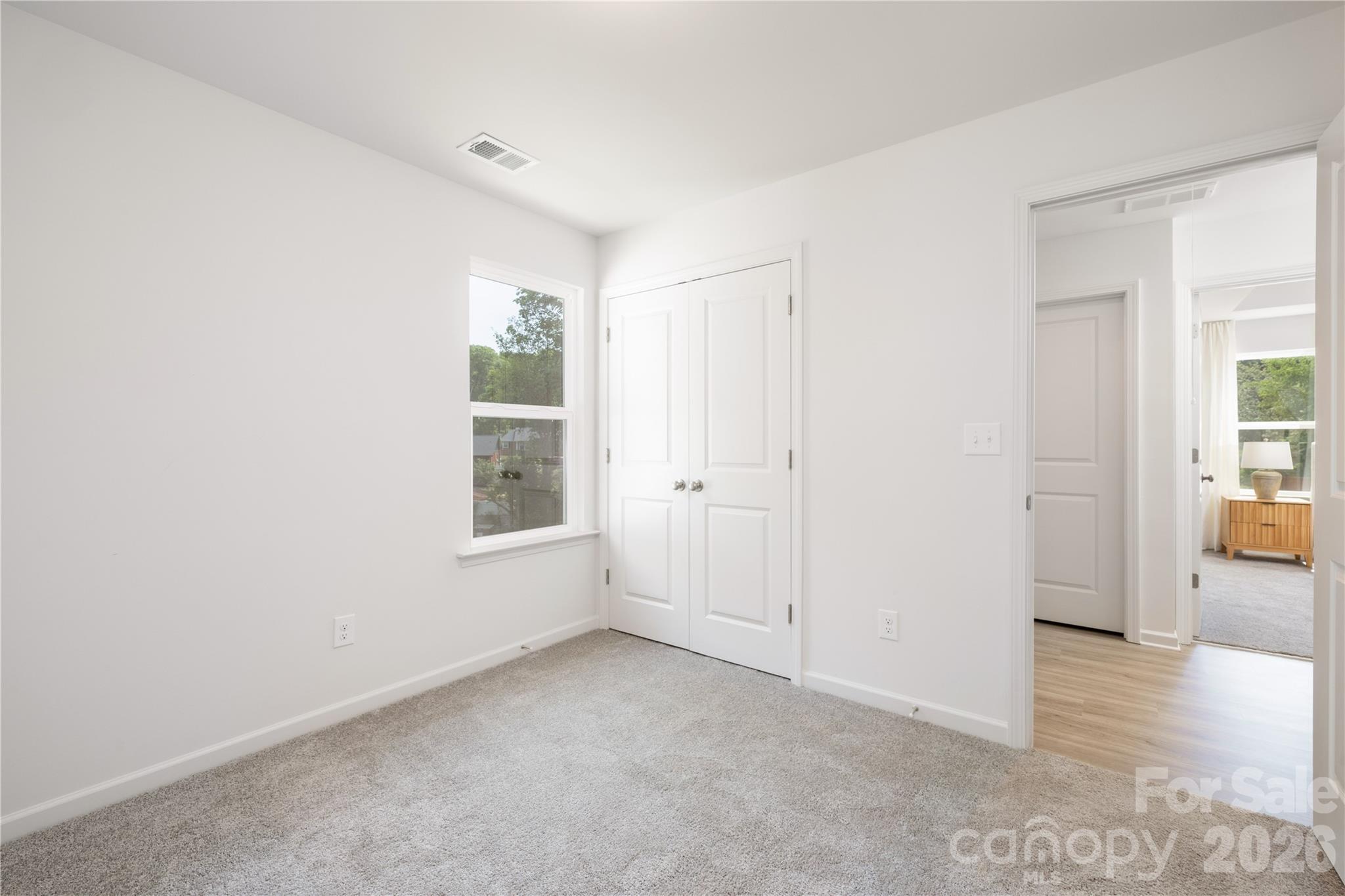 5514 Anderson Road Charlotte, NC 28269 - Photo 6 of 20 a view of an empty room with window and wooden floor