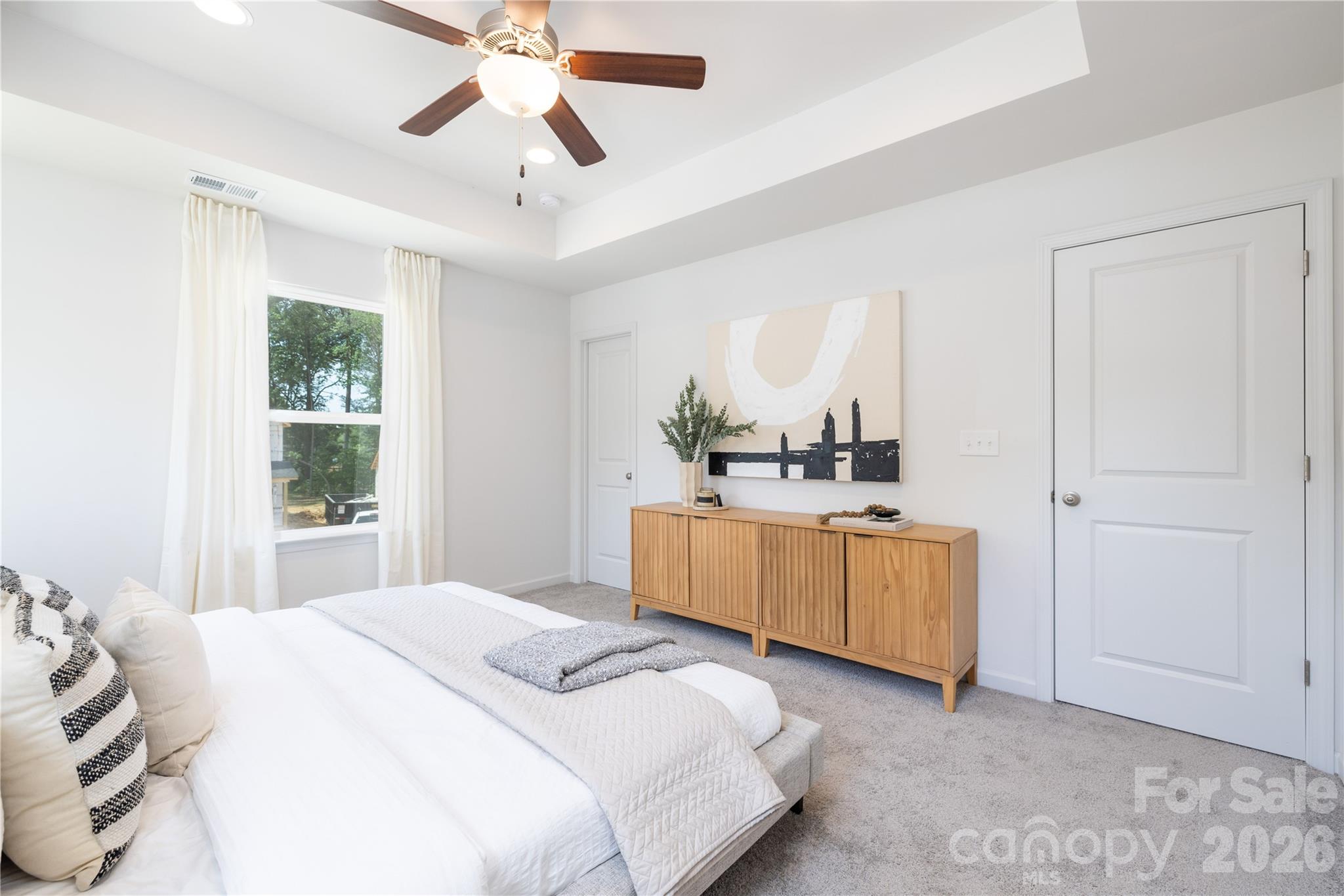 5514 Anderson Road Charlotte, NC 28269 - Photo 10 of 20 a bedroom with a large bed a chandelier and dresser