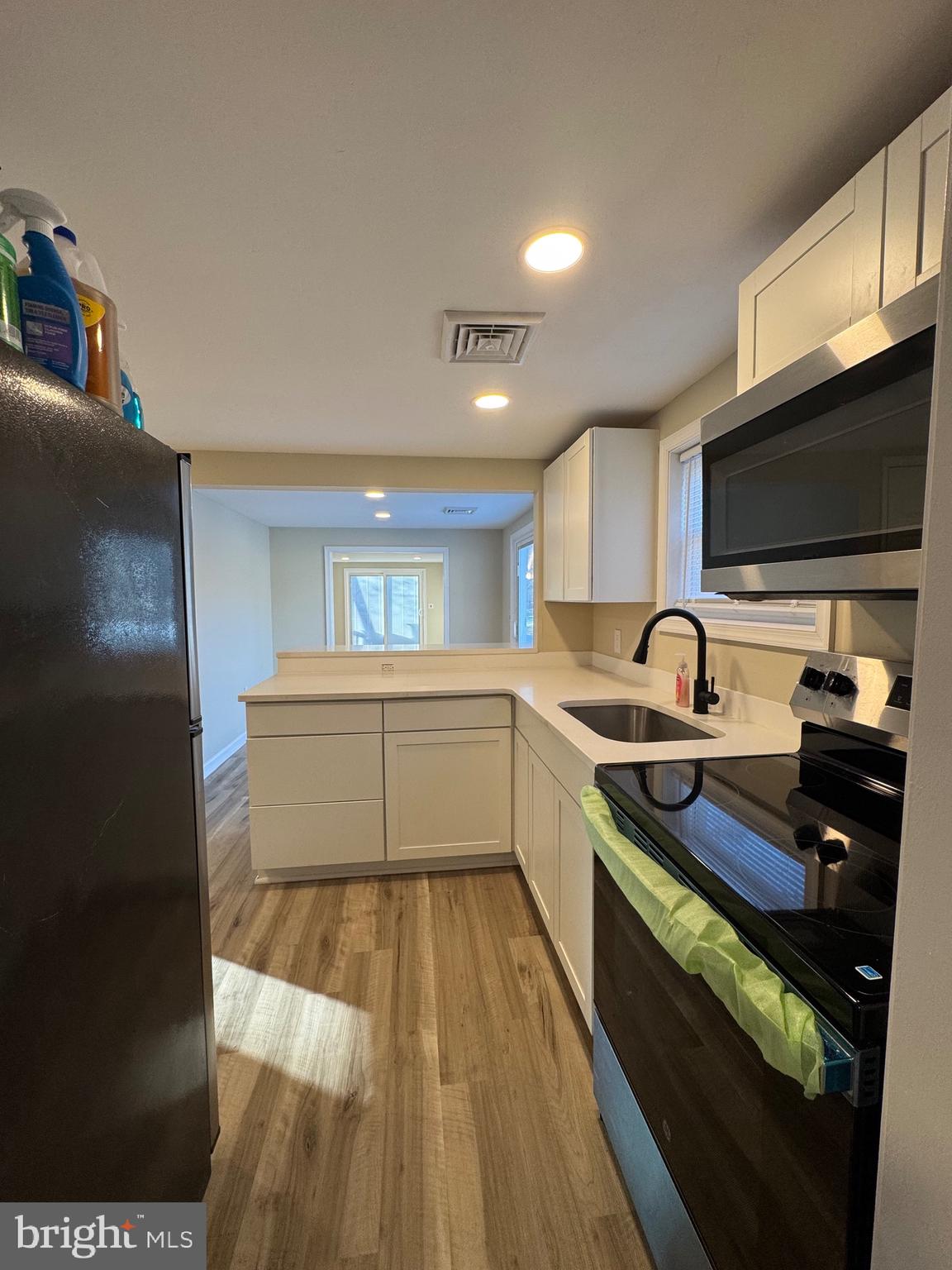 2389 White Oak Road Dover, DE 19901 - Photo 11 of 25 a kitchen with granite countertop a stove and a sink