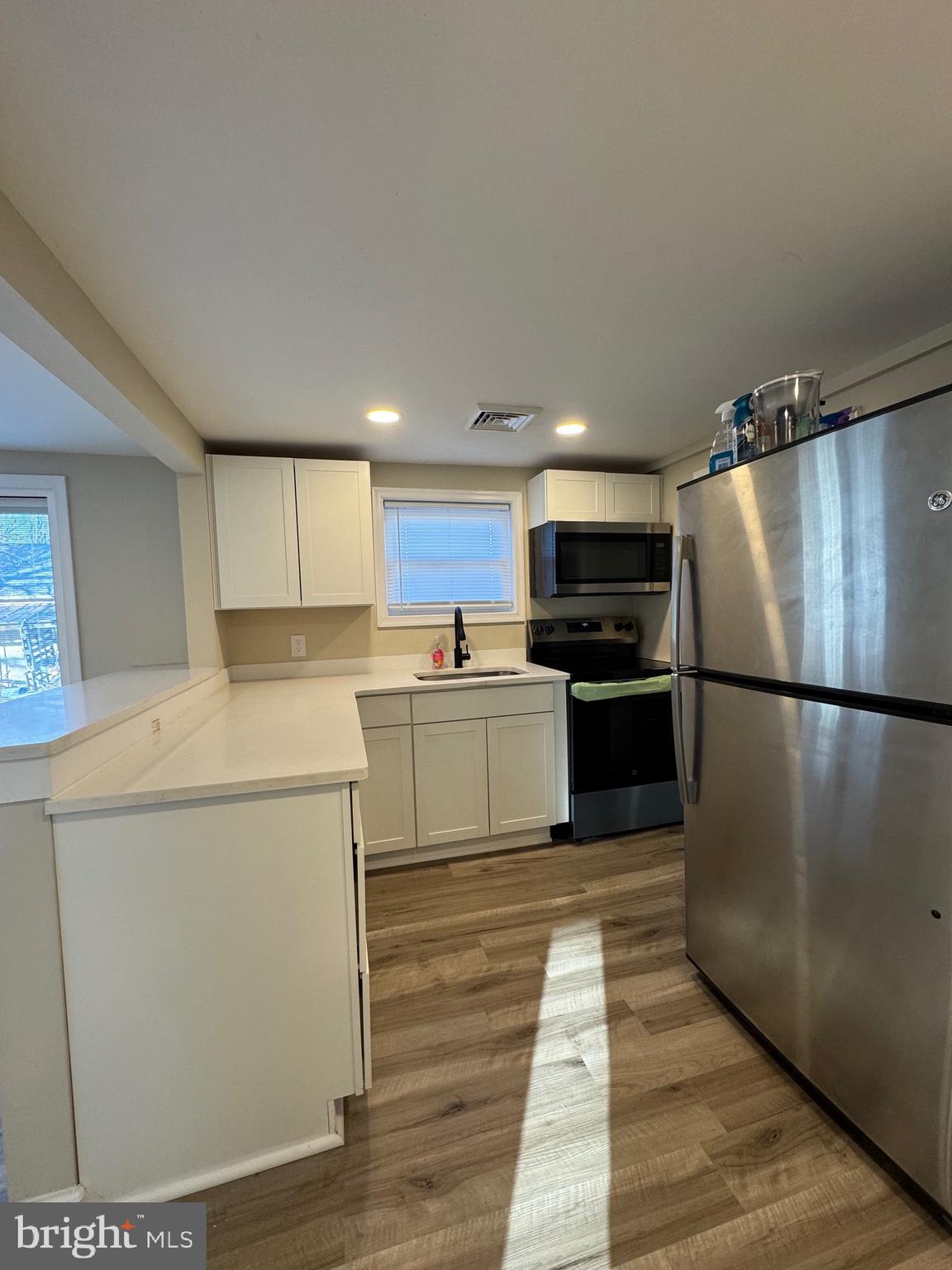 2389 White Oak Road Dover, DE 19901 - Photo 13 of 25 a kitchen with a refrigerator a stove top oven and cabinets