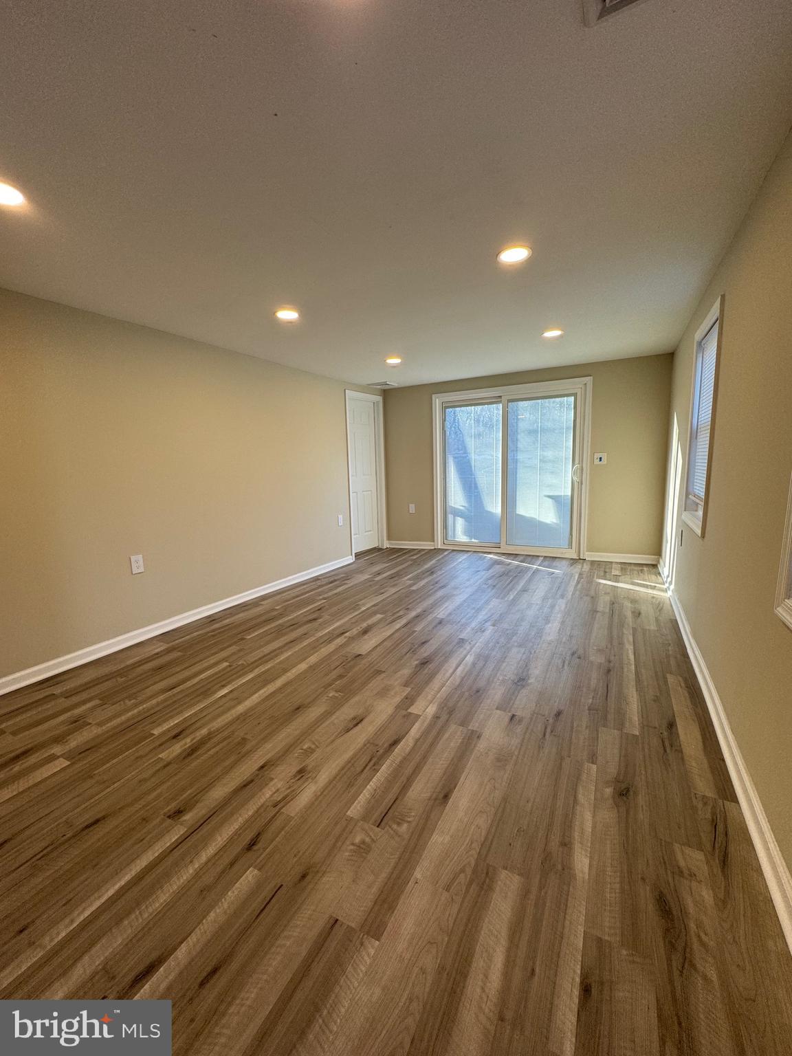 2389 White Oak Road Dover, DE 19901 - Photo 21 of 25 an empty room with wooden floor and windows
