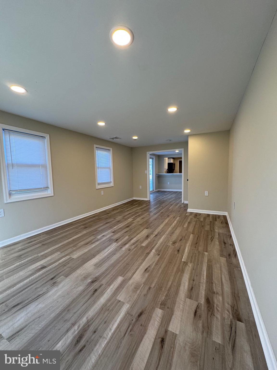 2389 White Oak Road Dover, DE 19901 - Photo 22 of 25 an empty room with wooden floor and windows