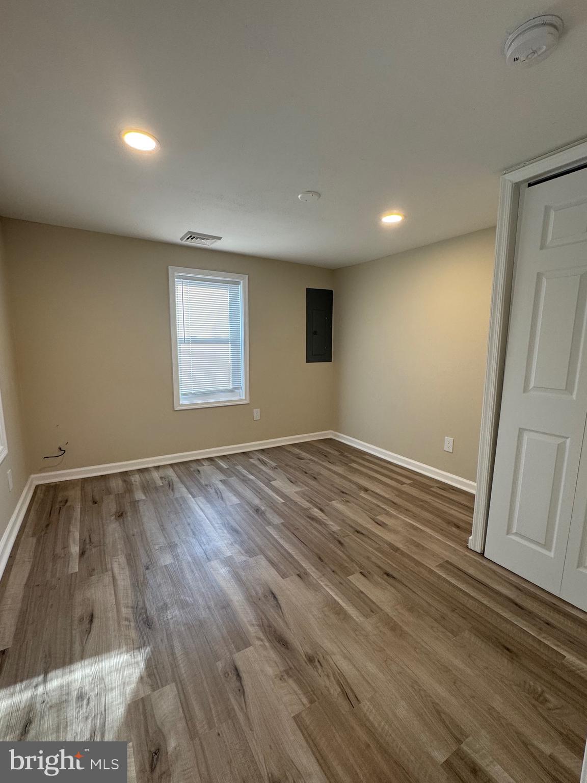 2389 White Oak Road Dover, DE 19901 - Photo 9 of 25 an empty room with wooden floor and window