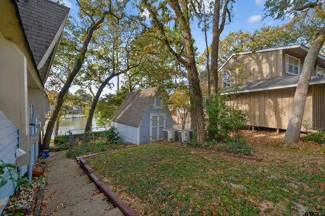 a view of a house with a tree in the yard