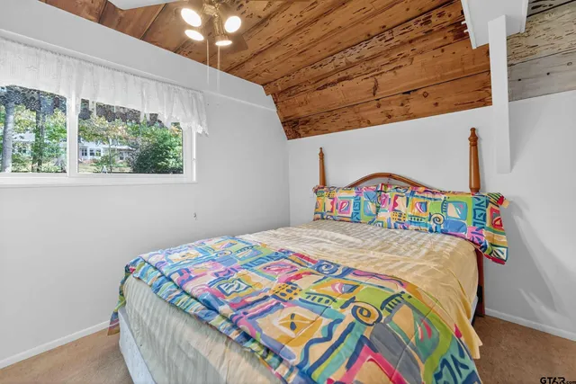 a bedroom with a bed a stove and a window