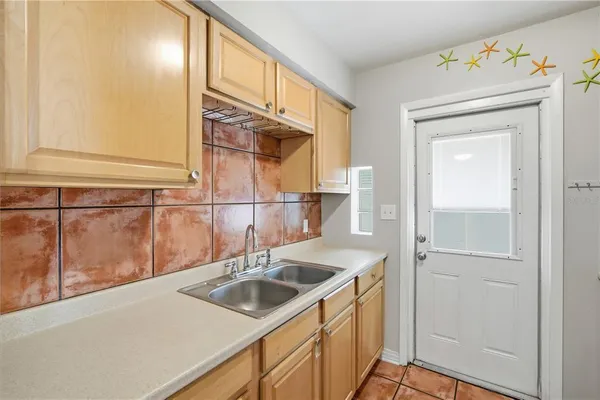 a kitchen with a sink and a refrigerator