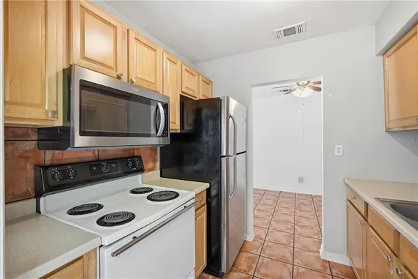 a kitchen with stainless steel appliances a stove a microwave and a refrigerator