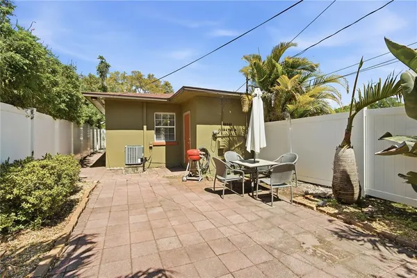 a view of a patio with table and chairs and potted plants