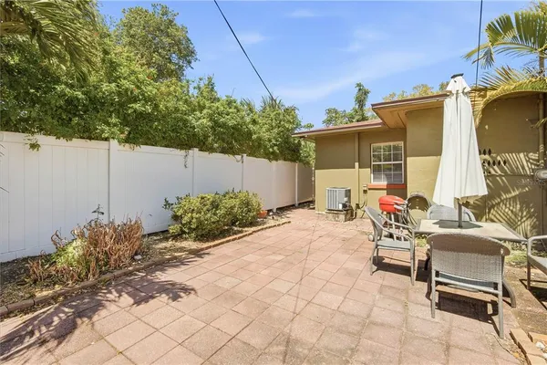 a view of a backyard with plants and a patio