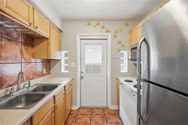 a kitchen with a sink and refrigerator