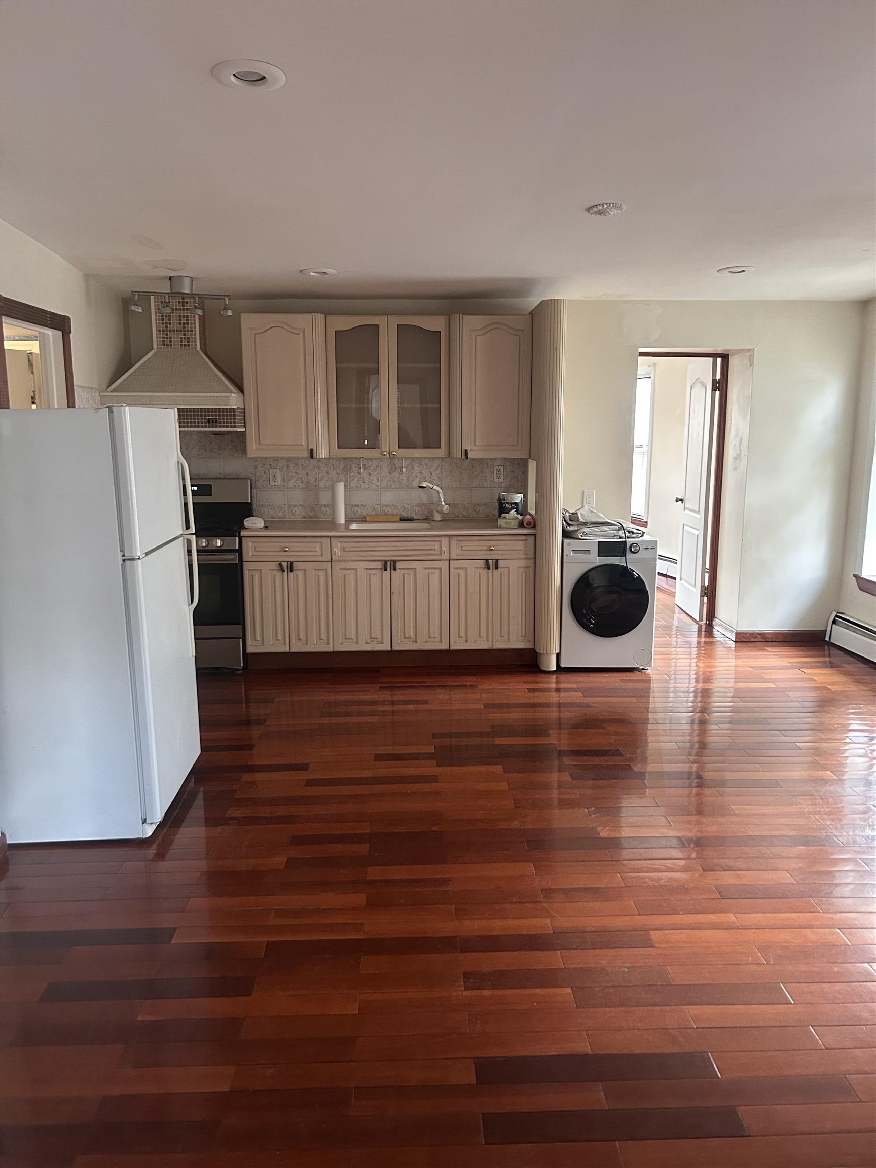 236 Grove Street Jersey City, NJ 07302 - Photo 3 of 7 a room with furniture and a wooden floor