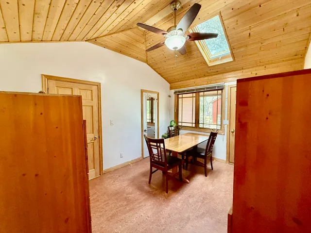 a bedroom with a bed and a refrigerator