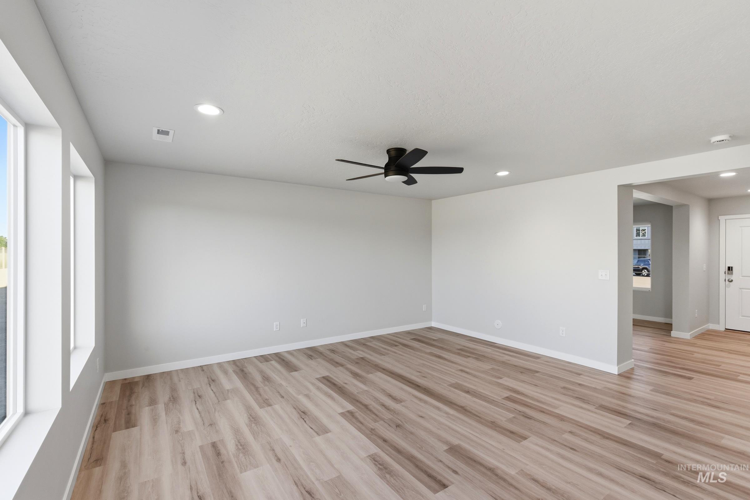 13709 Redway Court Caldwell, ID 83607 - Photo 8 of 28 Spacious interior featuring wood-finish flooring, recessed lighting, and a contemporary ceiling fan
