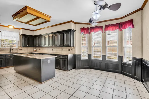 a kitchen with stainless steel appliances granite countertop a stove a sink dishwasher and a refrigerator with wooden cabinets