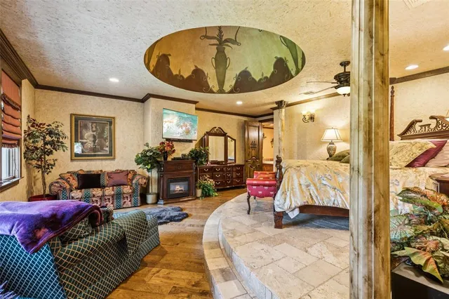 a living room with furniture a fireplace and a chandelier