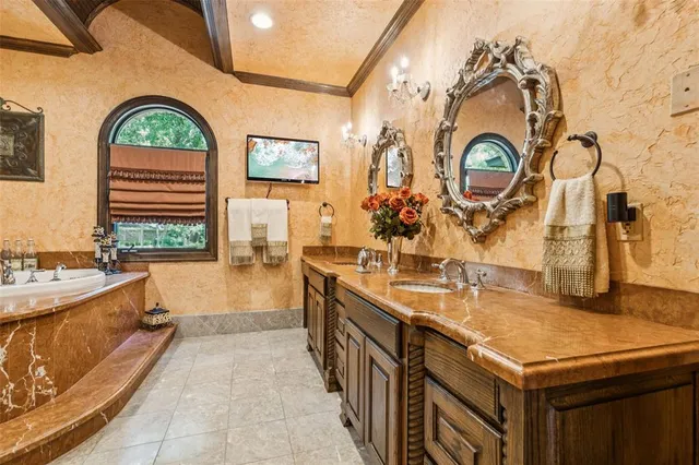 a large bathroom with a large tub sink and mirror