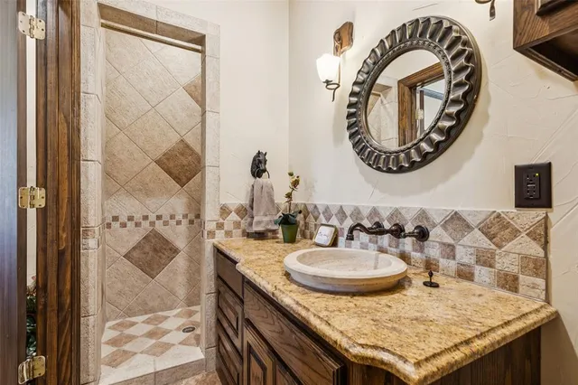 a kitchen with stainless steel appliances granite countertop a stove and a clock on the wall