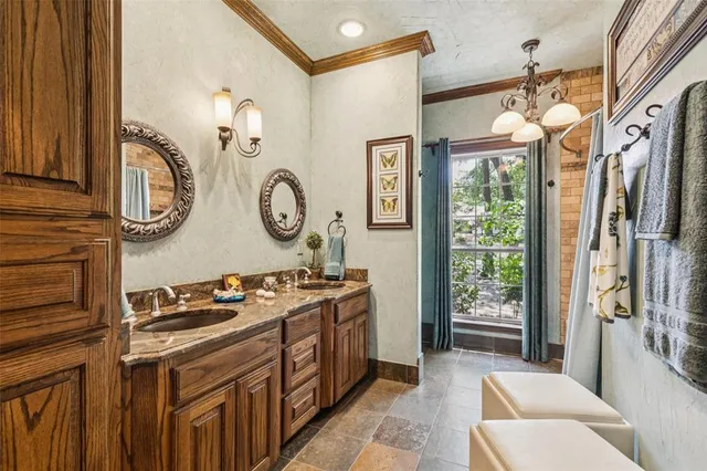 a bathroom with a granite countertop toilet sink and mirror