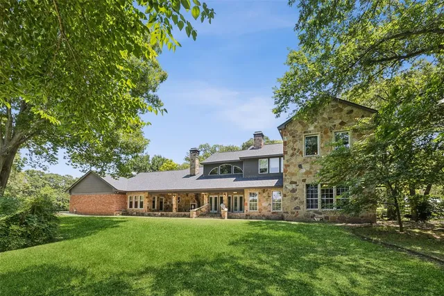an aerial view of residential house with outdoor space and swimming pool