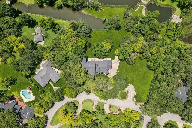view of a green field with lots of bushes