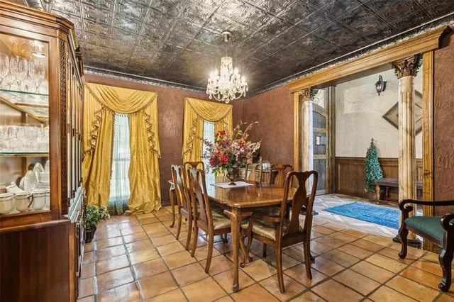 a view of a dining room with furniture and a chandelier