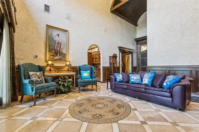 a living room with furniture a rug and a dining table
