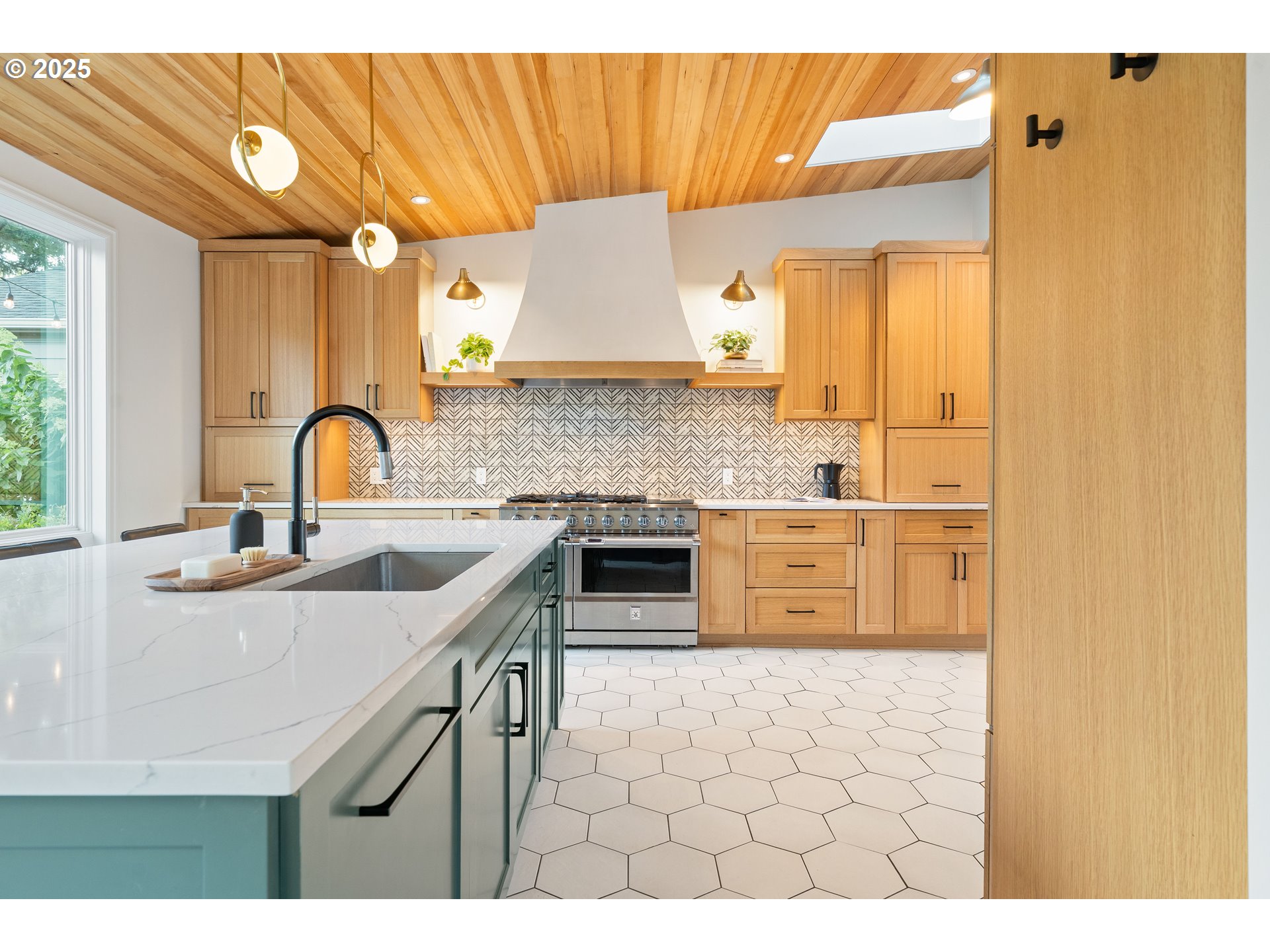 6328 Southwest Brugger Street Portland, OR 97219 - Photo 11 of 48 a kitchen with stainless steel appliances a sink and a stove