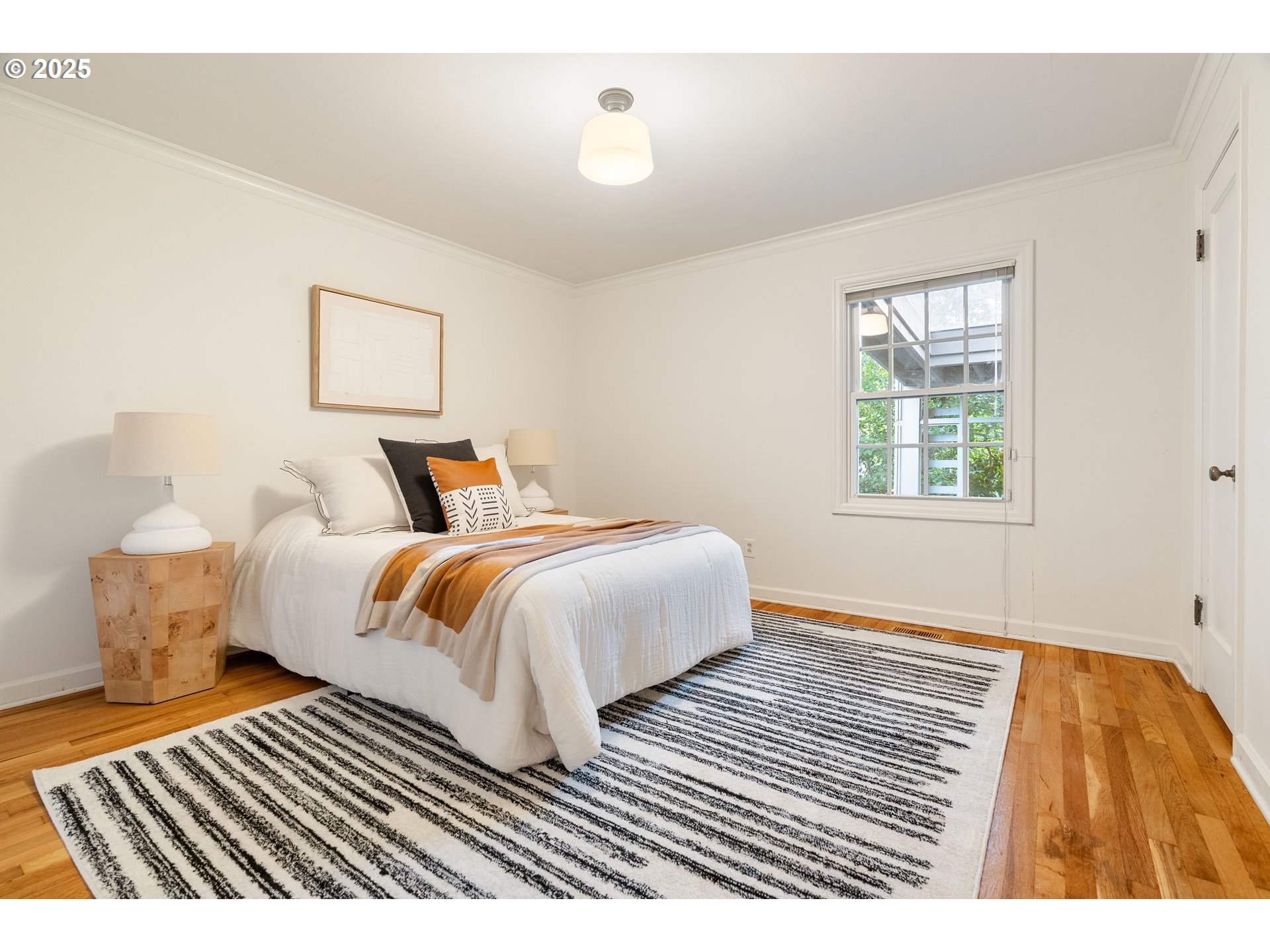 6328 Southwest Brugger Street Portland, OR 97219 - Photo 25 of 48 a bedroom with a bed and wooden floor