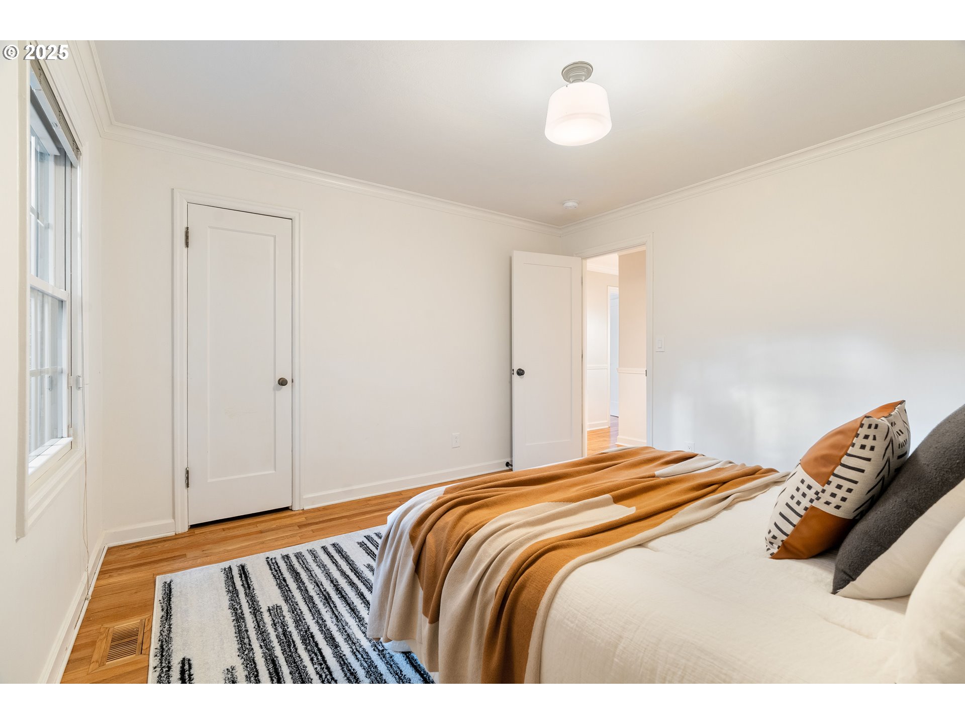 6328 Southwest Brugger Street Portland, OR 97219 - Photo 26 of 48 a bedroom with a bed and a window