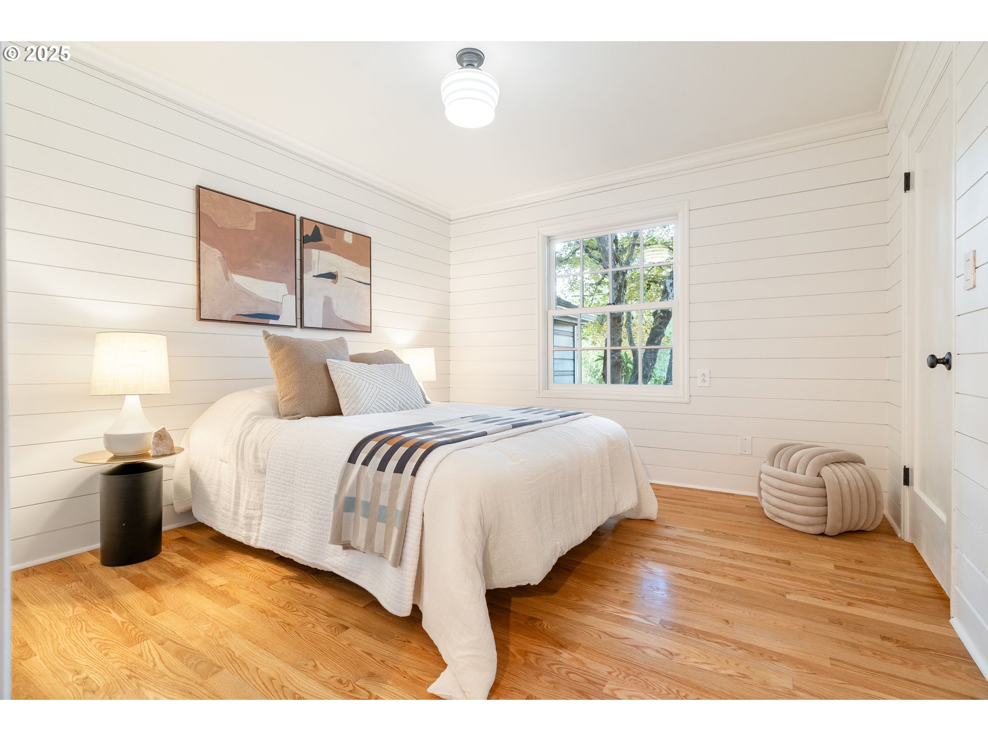 6328 Southwest Brugger Street Portland, OR 97219 - Photo 27 of 48 a bedroom with a bed and wooden floor