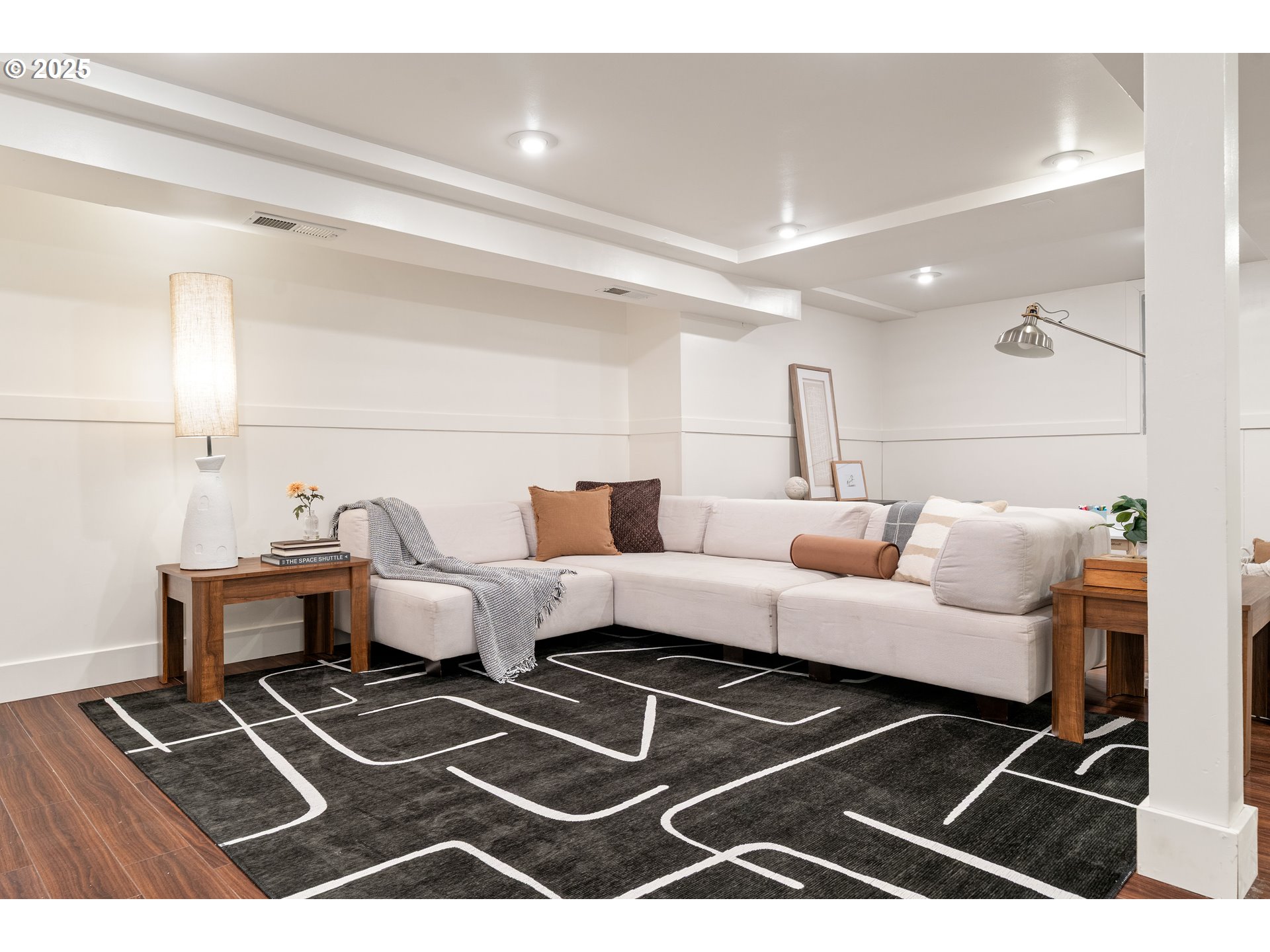 6328 Southwest Brugger Street Portland, OR 97219 - Photo 31 of 48 a living room with a couch and a rug