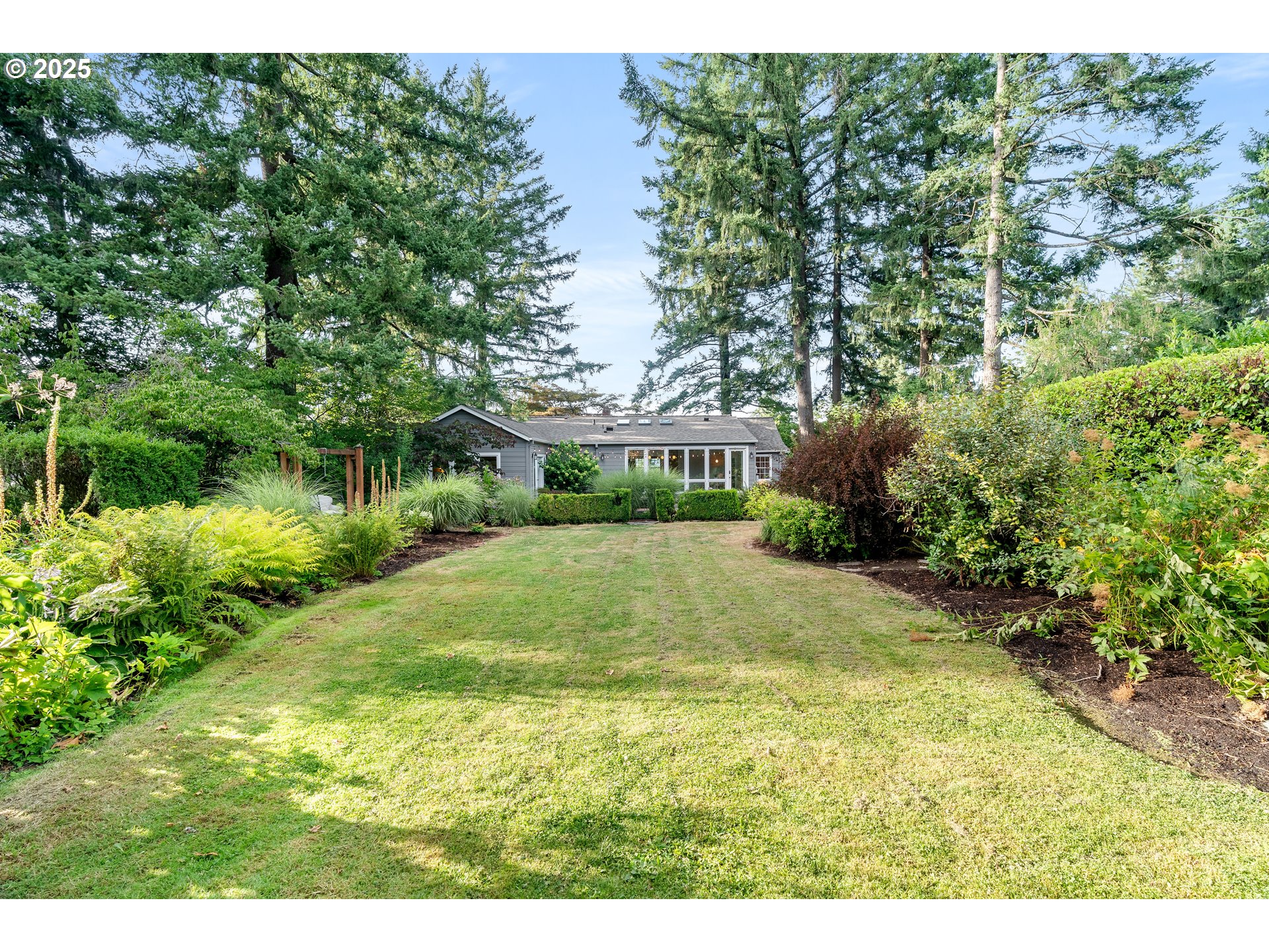 6328 Southwest Brugger Street Portland, OR 97219 - Photo 37 of 48 a view of a yard with plants and trees