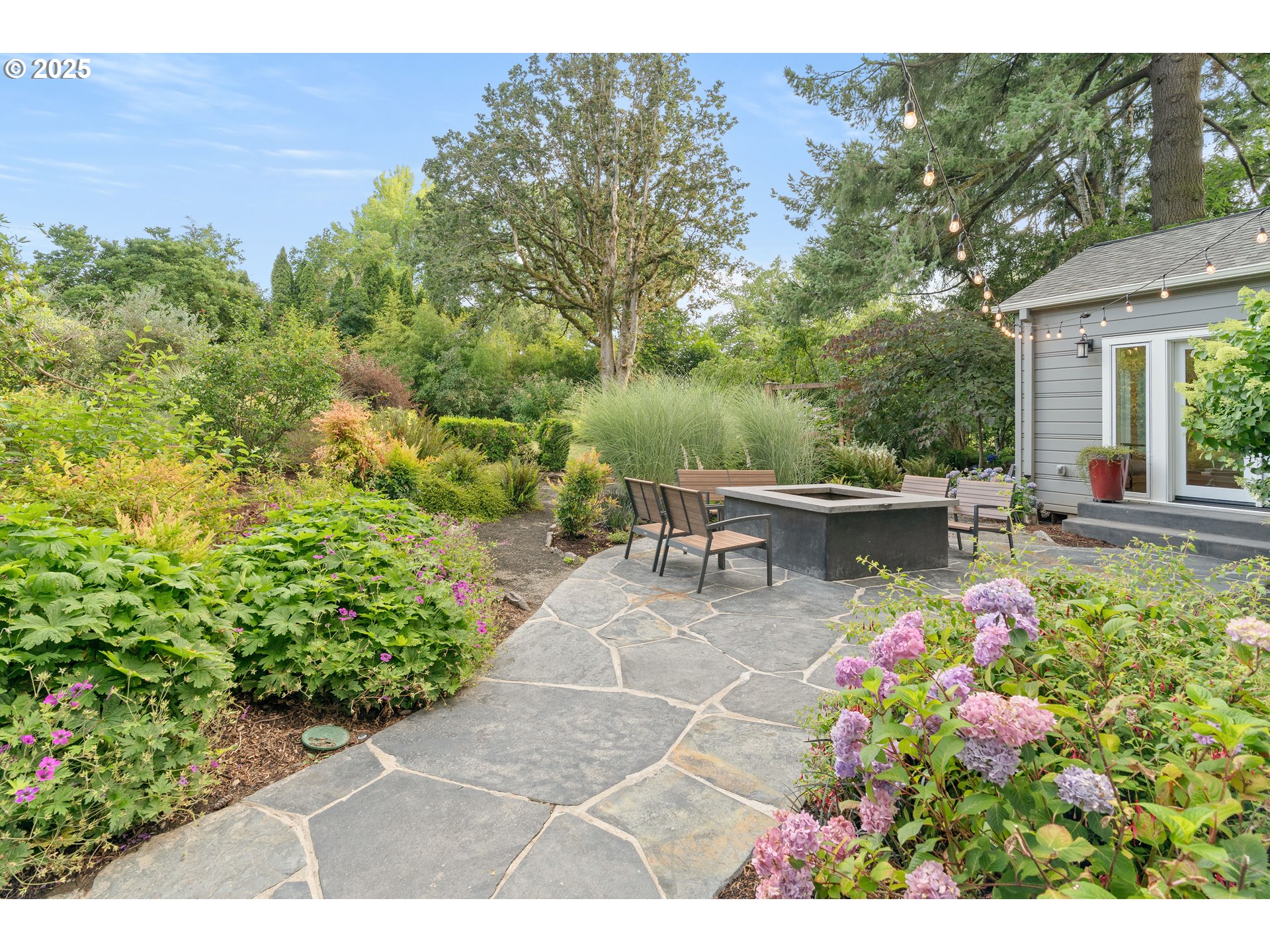 6328 Southwest Brugger Street Portland, OR 97219 - Photo 38 of 48 a view of a chair and table on the garden