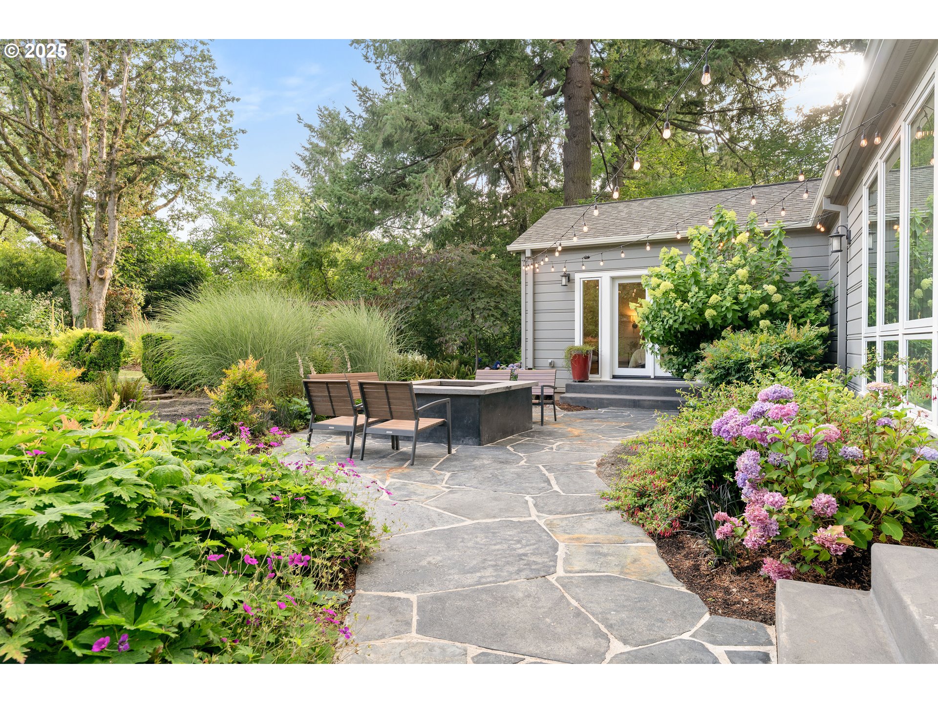 6328 Southwest Brugger Street Portland, OR 97219 - Photo 39 of 48 a view of a patio with chairs and potted plants