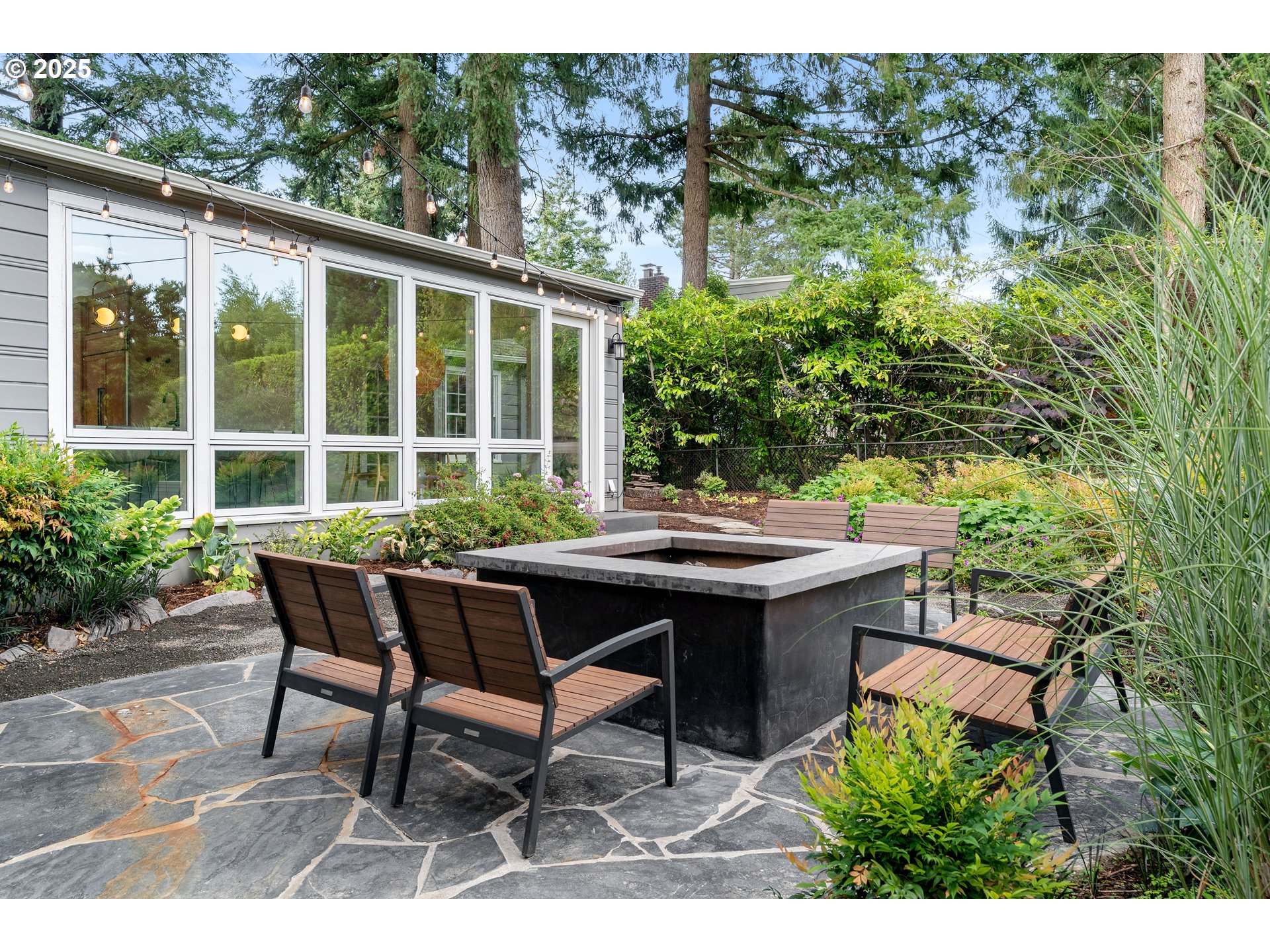 6328 Southwest Brugger Street Portland, OR 97219 - Photo 40 of 48 a view of a table and chairs in back yard of a house