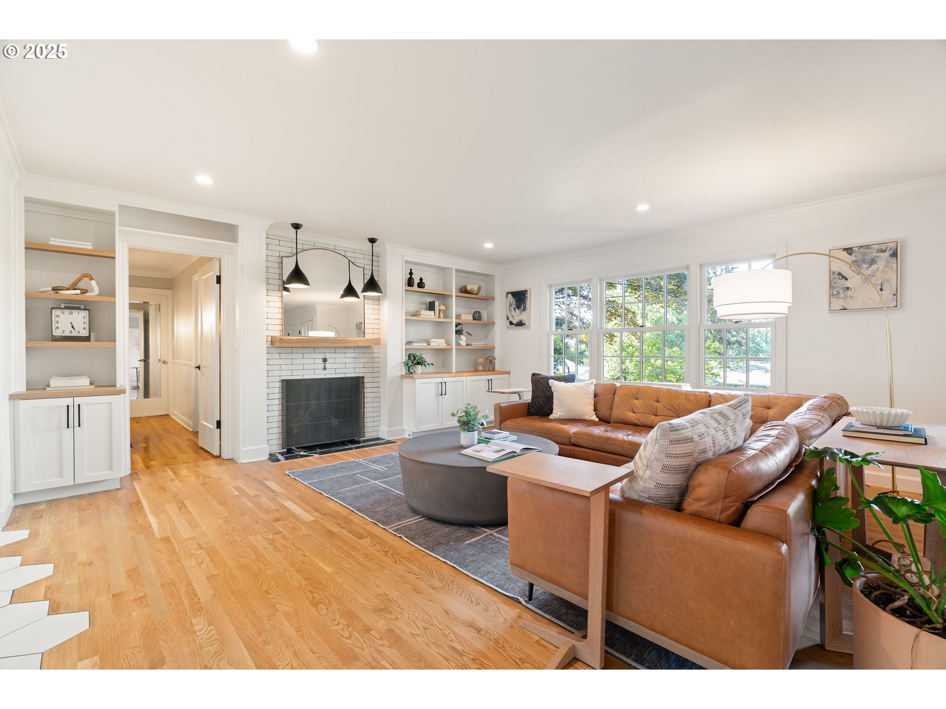 6328 Southwest Brugger Street Portland, OR 97219 - Photo 4 of 48 a living room with furniture a fireplace and a flat screen tv