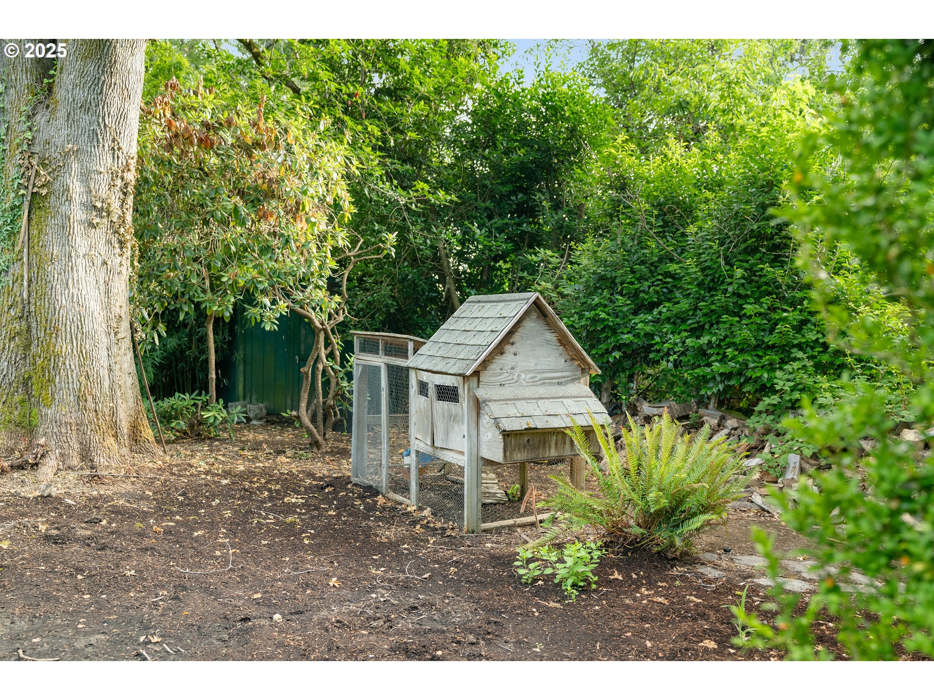 6328 Southwest Brugger Street Portland, OR 97219 - Photo 44 of 48 a front view of a house with a garden