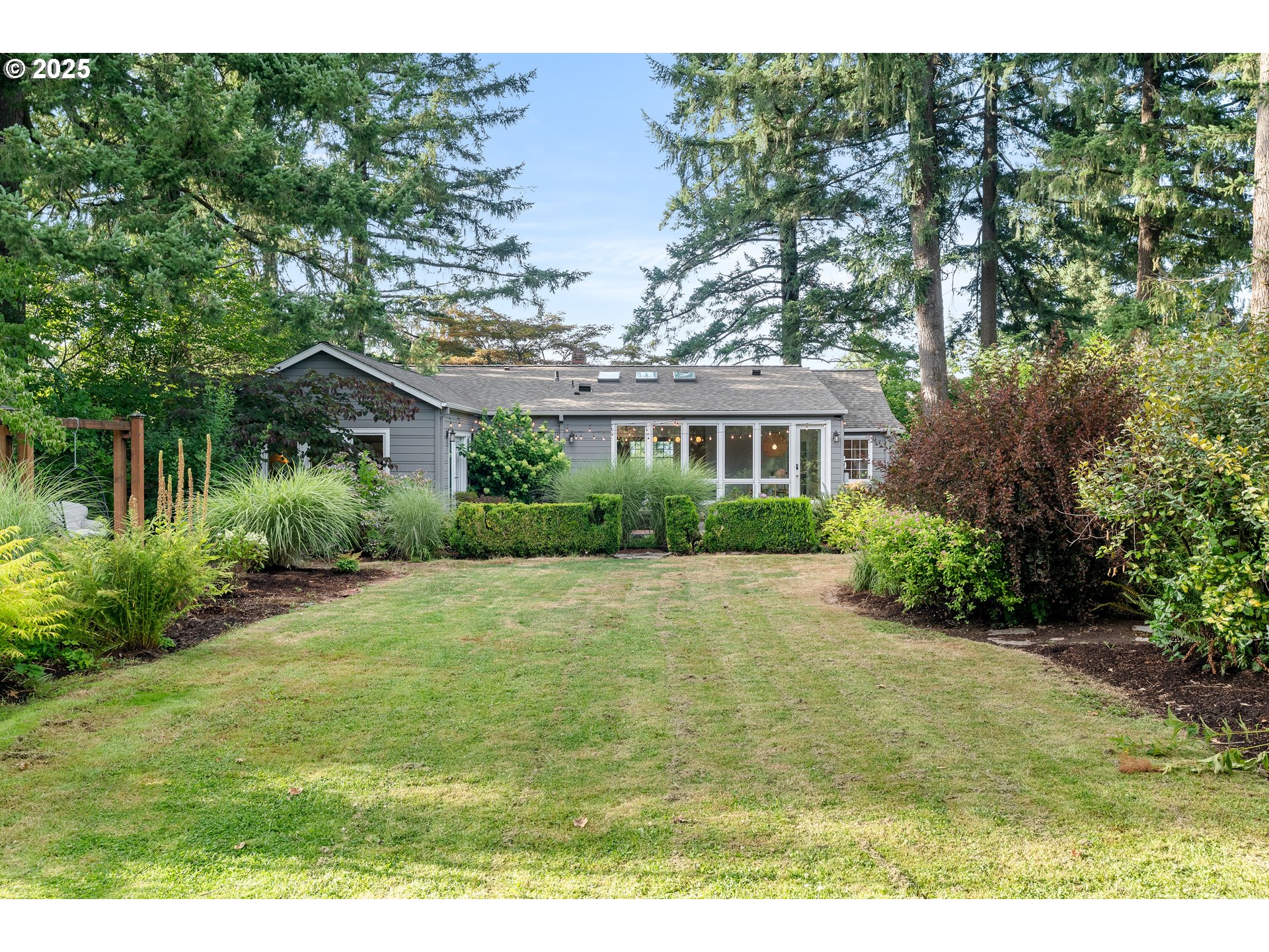 6328 Southwest Brugger Street Portland, OR 97219 - Photo 46 of 48 a view of an house with backyard space and garden