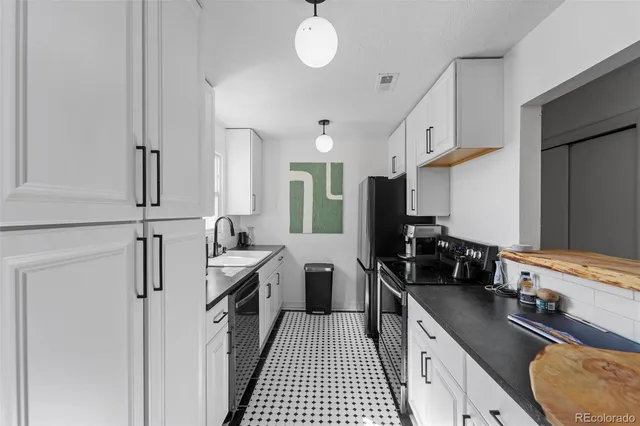a kitchen with a sink stove and refrigerator